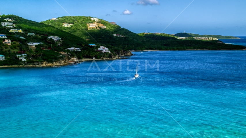 A sailboat near the Caribbean island coast with upscale homes, Southside, St Thomas Aerial Stock Photo AX102_234.0000000F | Axiom Images