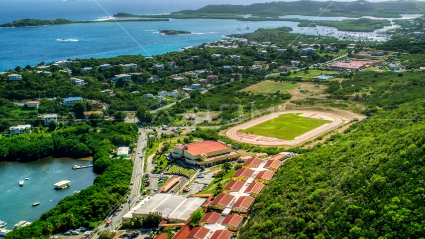 Island high school and track field near waterfront homes in East End, St Thomas, US Virgin Islands Aerial Stock Photo AX102_244.0000000F | Axiom Images