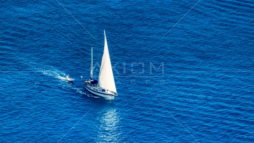 Sailboat in sapphire blue Caribbean waters, St Thomas, USVI Aerial Stock Photo AX102_256.0000138F | Axiom Images