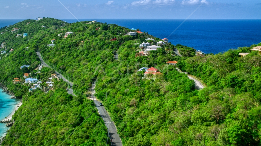 Oceanfront hillside homes with a view of turquoise Caribbean waters, Magens Bay, St Thomas Aerial Stock Photo AX102_274.0000000F | Axiom Images