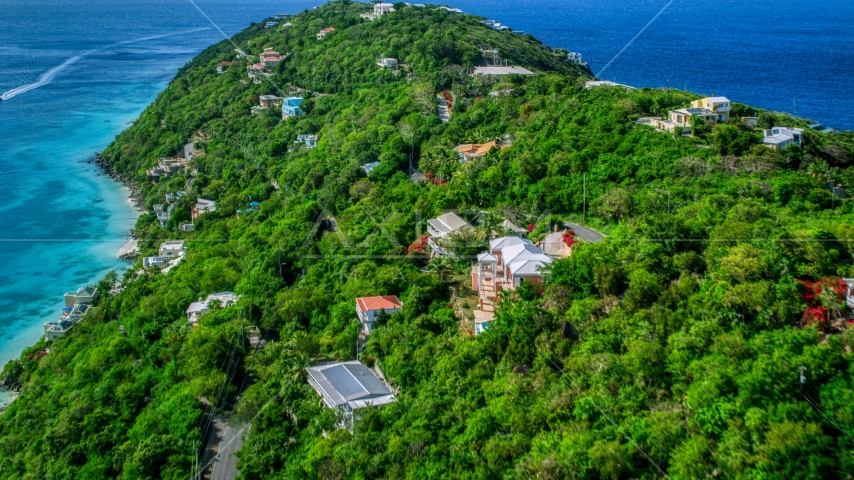 Oceanfront hillside island homes near Caribbean waters, Magens Bay, St Thomas Aerial Stock Photo AX102_274.0000327F | Axiom Images
