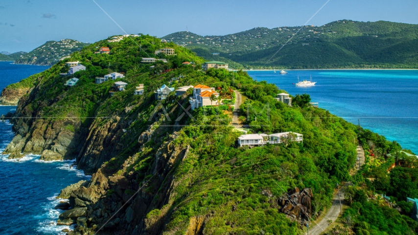 Hillside oceanfront homes by sapphire blue Caribbean waters, Magens Bay, St Thomas Aerial Stock Photo AX102_281.0000033F | Axiom Images