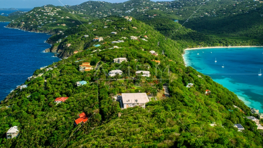 Oceanfront hillside island homes near sapphire blue Caribbean waters, Magens Bay, St Thomas Aerial Stock Photo AX102_282.0000315F | Axiom Images