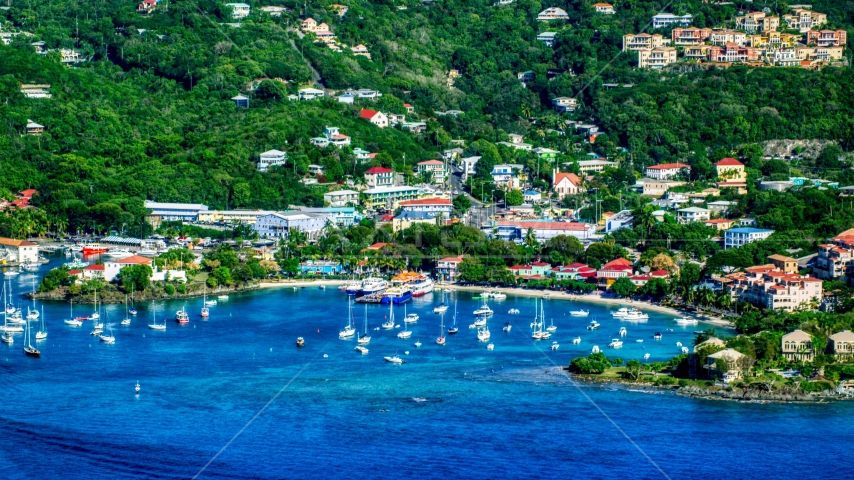 A coastal town and boats in the harbor with Caribbean blue waters, Cruz Bay, St John Aerial Stock Photo AX103_018.0000094F | Axiom Images