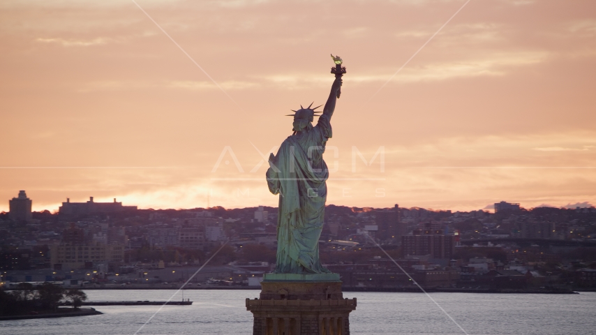 Statue of Liberty with a view of Brooklyn at sunrise, New York Aerial Stock Photos AX118_042.0000000F | Axiom Images