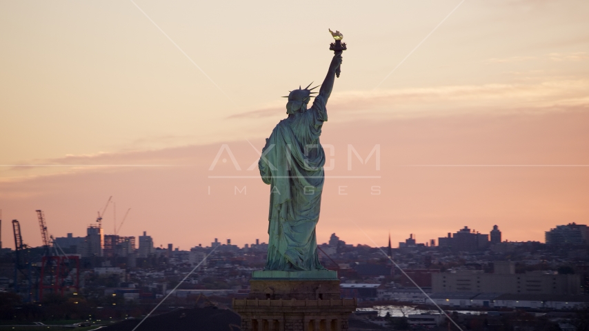 Behind the Statue of Liberty at sunrise, New York Aerial Stock Photos AX118_042.0000234F