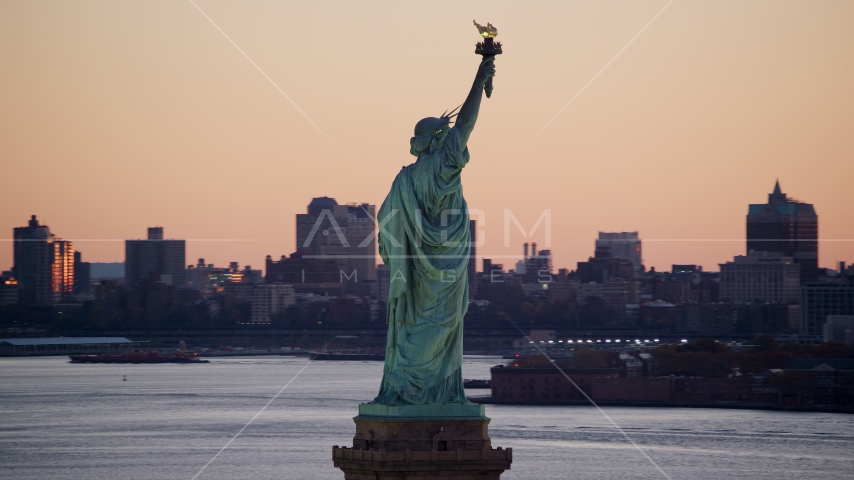 Statue of Liberty, and Brooklyn across the harbor at sunrise, New York Aerial Stock Photos AX118_044.0000000F