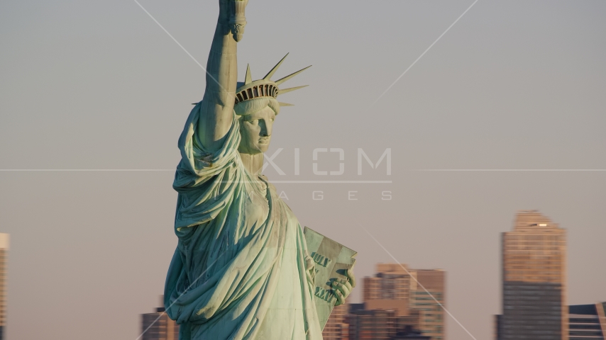 Profile of the Statue of Liberty at sunrise in New York Aerial Stock Photos AX118_108.0000070F