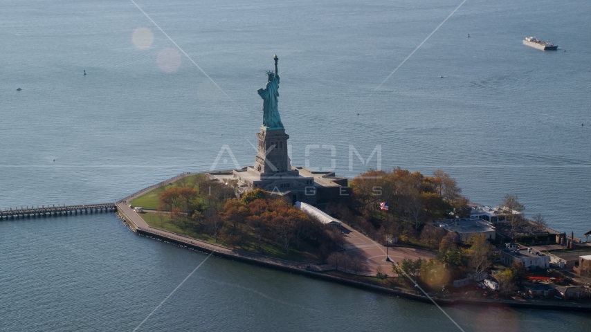 The back of Liberty Island and the Statue of Liberty in Autumn, New York Aerial Stock Photos AX119_013.0000083F