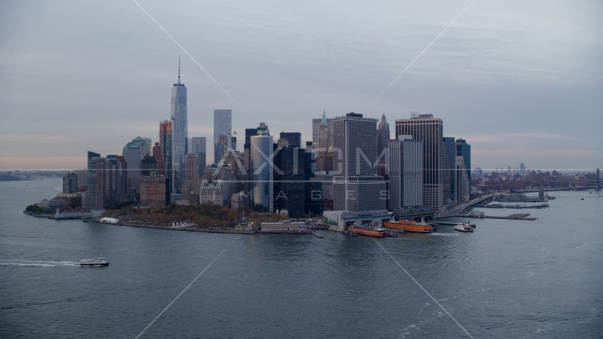 Battery Park, downtown skyline, and ferry terminal in Lower Manhattan at sunset, New York City Aerial Stock Photos AX121_019.0000105F