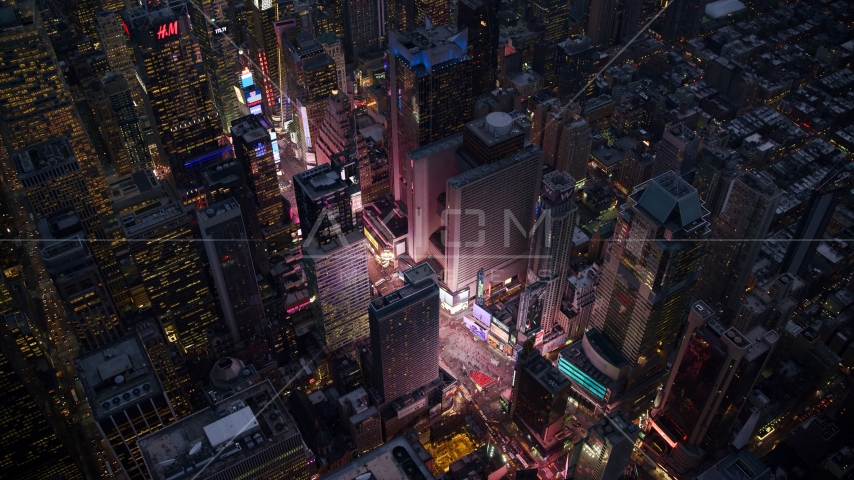 The bright lights and video screens of Times Square at sunset in Midtown, New York City Aerial Stock Photos AX121_105.0000243F