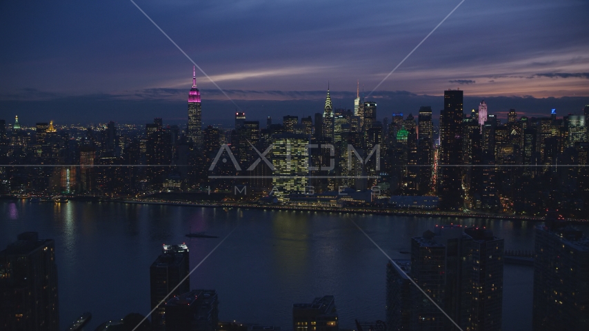 Midtown Manhattan across the East River at night in New York City Aerial Stock Photos AX121_144.0000032F