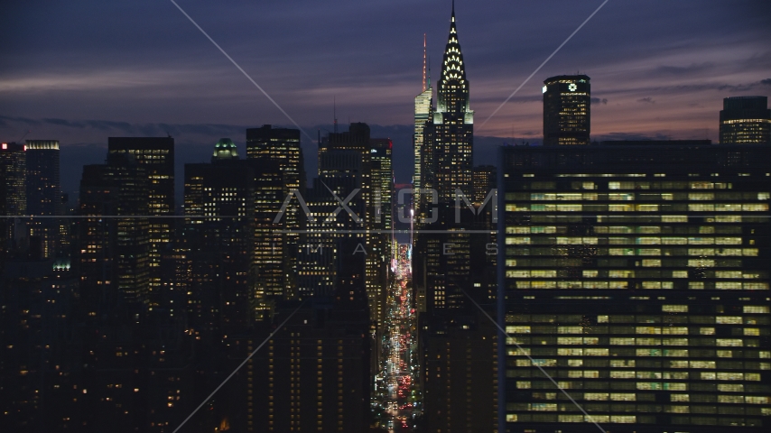 Midtown Manhattan city canyon by Chrysler Building and UN at night in New York City Aerial Stock Photos AX121_151.0000084F