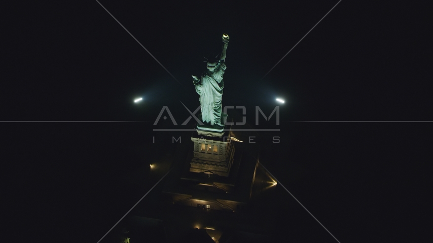 A bird's eye of the Statue of Liberty at nighttime in New York Aerial Stock Photos AX121_196.0000217F