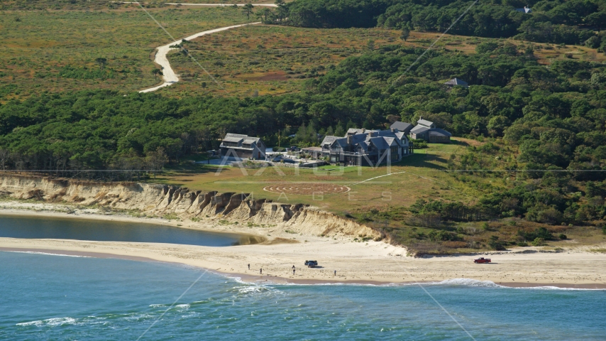 An isolated beachfront mansion and trucks on the beach, Chappaquiddick Island, Martha's Vineyard, Massachusetts Aerial Stock Photo AX144_124.0000000 | Axiom Images