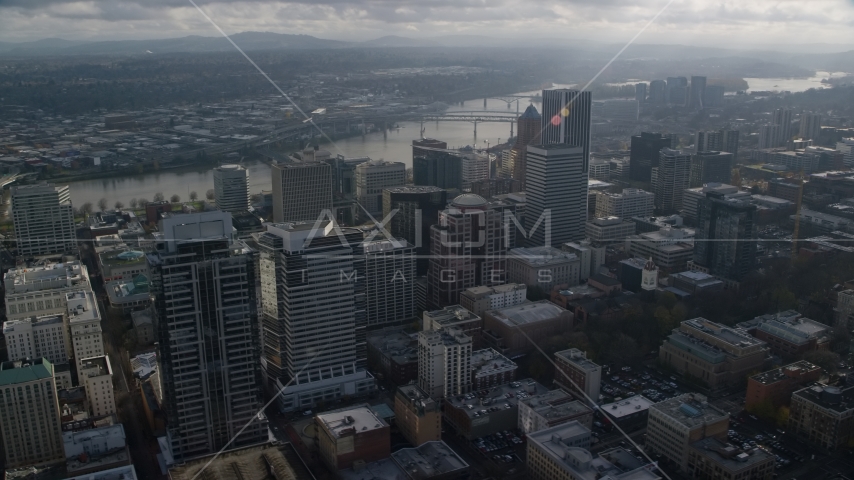 Skyscrapers near bridges spanning the Willamette River in Downtown Portland, Oregon Aerial Stock Photos AX153_110.0000000F