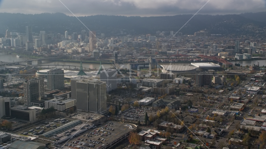 Downtown Portland skyscrapers across the river from office buildings and Moda Center in Oregon Aerial Stock Photos AX153_112.0000000F