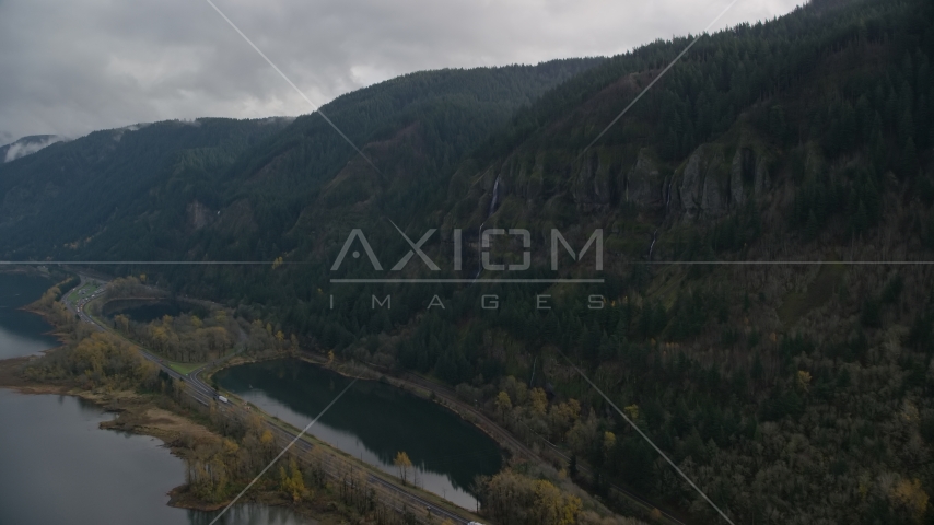 A waterfall on a Columbia River Gorge cliff face in Multnomah County, Oregon Aerial Stock Photos AX154_018.0000000F
