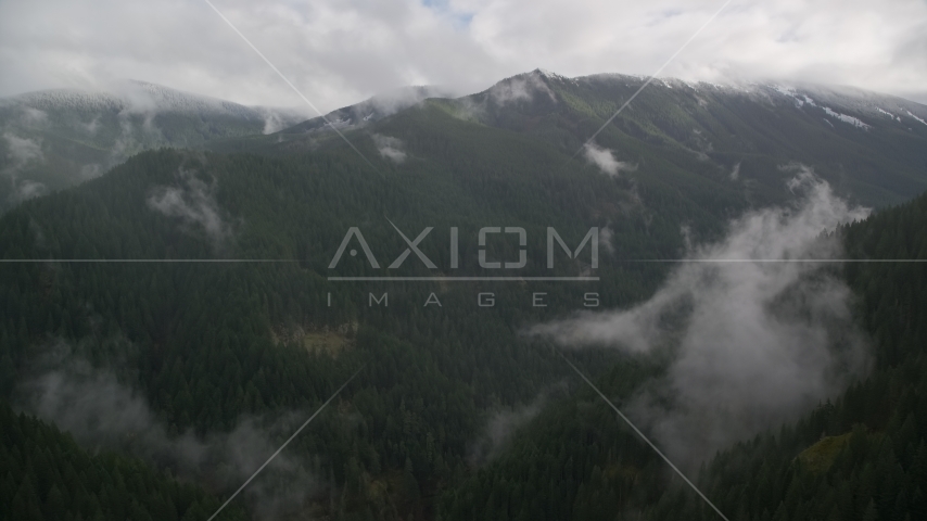 A mountain ridge with light snow at the end of a misty canyon in Cascade Range, Hood River County, Oregon Aerial Stock Photos AX154_052.0000388F