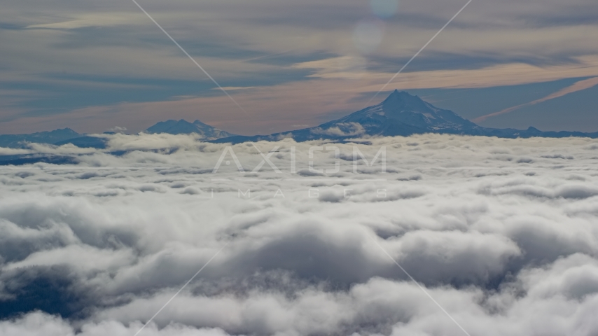 Mount Jefferson and the Three Sisters Volcanoes seen from across low clouds, Cascade Range, Oregon Aerial Stock Photos AX154_098.0000218F