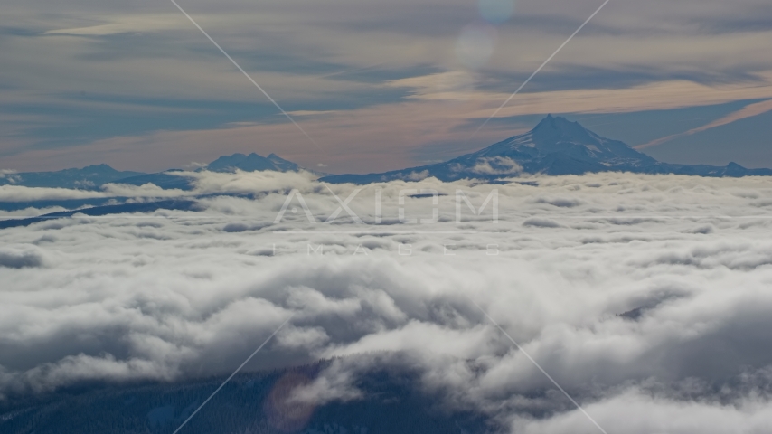 Mount Jefferson and Three Sisters Volcanoes, seen above the clouds, Cascade Range, Oregon Aerial Stock Photos AX154_099.0000300F | Axiom Images