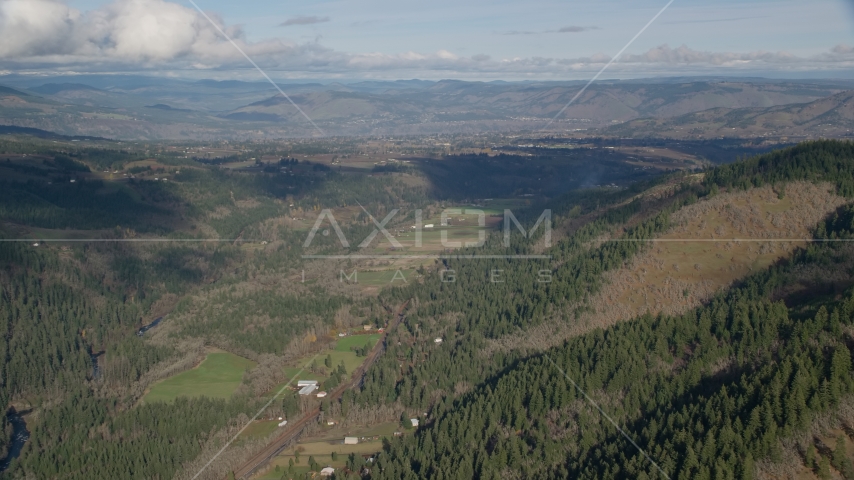 Farms and evergreen forest in a canyon, Hood River, Oregon Aerial Stock Photos AX154_148.0000145F