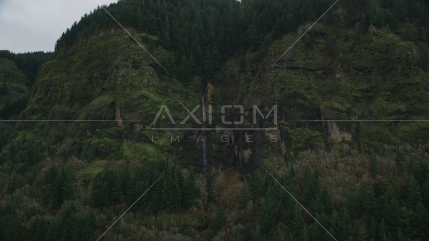 A waterfall on steep green cliffs on the Oregon side of Columbia River Gorge Aerial Stock Photos AX154_187.0000134F