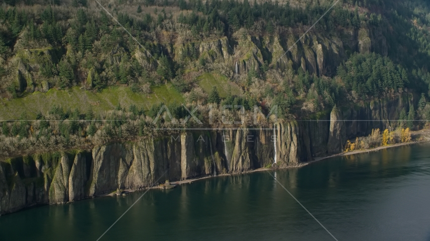 Four waterfalls on steep green cliffs and Columbia River on the Washington side of Columbia River Gorge Aerial Stock Photos AX154_195.0000000F