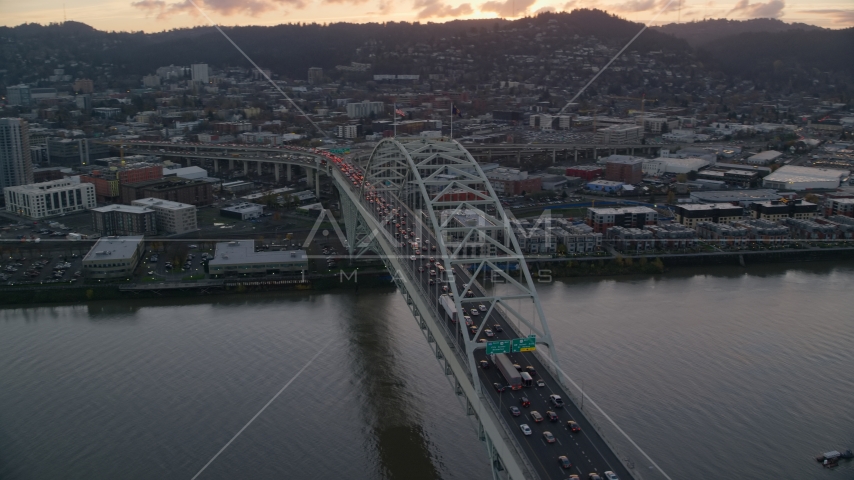 Heavy traffic crossing the Fremont Bridge at sunset in Downtown Portland, Oregon Aerial Stock Photo AX155_158.0000229F | Axiom Images