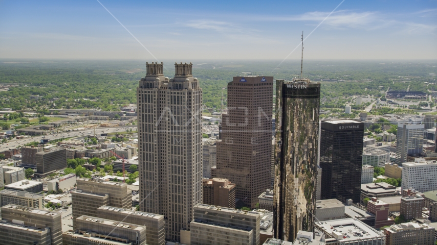 Skyscrapers towering over smaller office buildings, Downtown Atlanta, Georgia Aerial Stock Photo AX36_095.0000016F | Axiom Images
