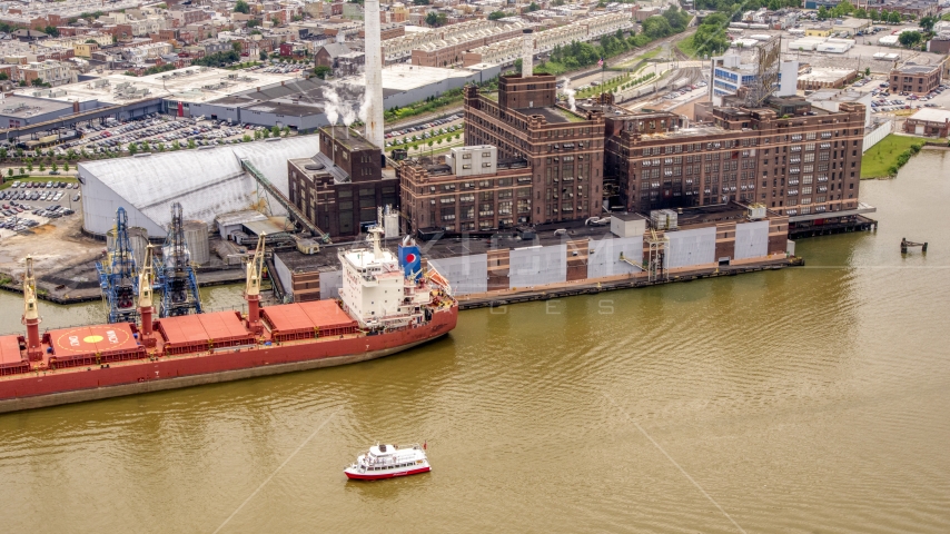 The Domino Sugar Factory and a docked cargo ship in Baltimore, Maryland Aerial Stock Photo AXP078_000_0012F | Axiom Images