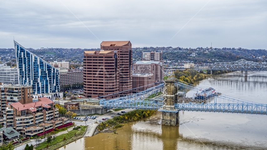 Condo complex and two office buildings by the Roebling Bridge spanning Ohio River in Covington, Kentucky Aerial Stock Photo DXP001_000465 | Axiom Images