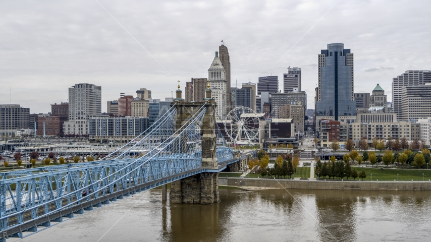 The side of the Roebling Bridge with the Ferris wheel and skyline in the distance, Downtown Cincinnati, Ohio Aerial Stock Photos DXP001_000472