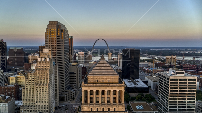 A view over the top of a courthouse to the Gateway Arch at twilight, Downtown St. Louis, Missouri Aerial Stock Photos DXP001_036_0005