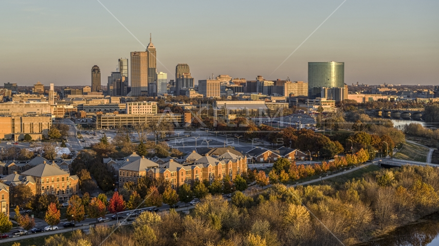 The city's skyline seen from the White River at sunset, Downtown Indianapolis, Indiana Aerial Stock Photos DXP001_092_0005