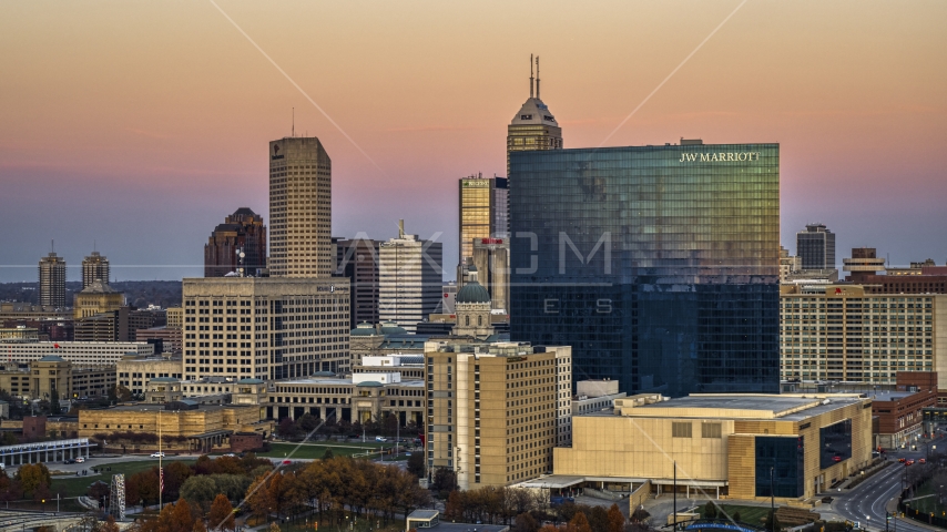 A hotel in front of the city's skyline at sunset, Downtown Indianapolis, Indiana Aerial Stock Photos DXP001_092_0016