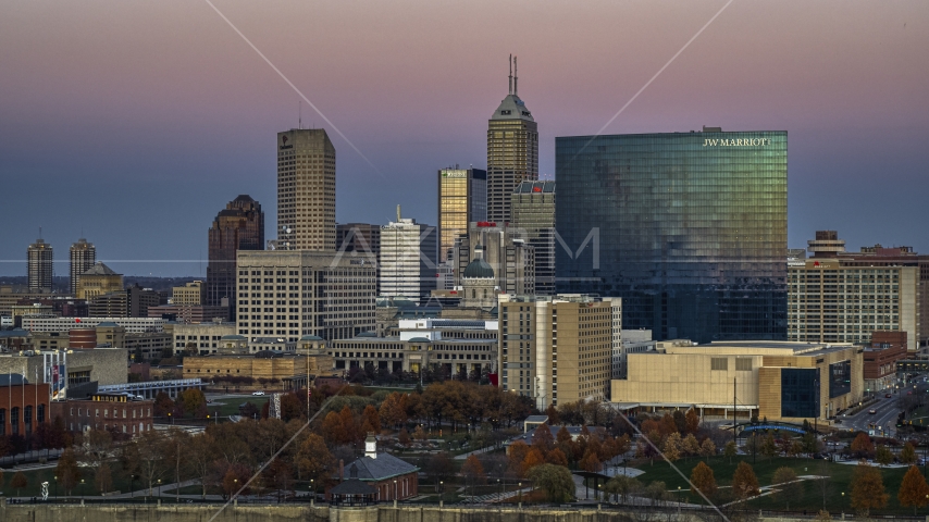 The city's tall skyline and a hotel at sunset in Downtown Indianapolis, Indiana Aerial Stock Photos DXP001_092_0020