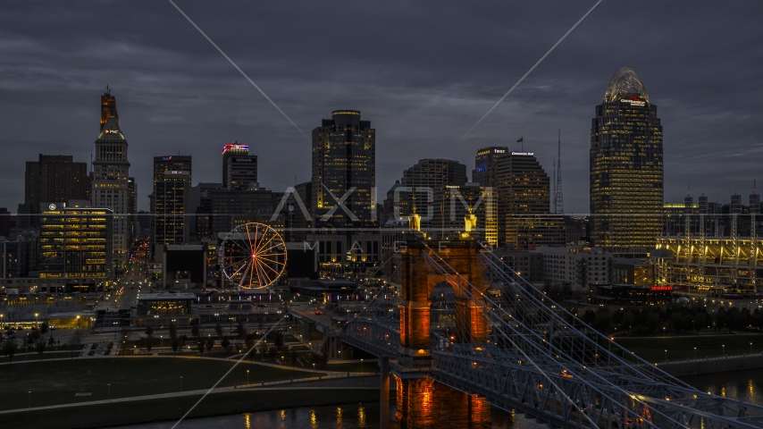 Roebling Bridge and city skyline lit up at twilight, Downtown Cincinnati, Ohio Aerial Stock Photos DXP001_098_0005