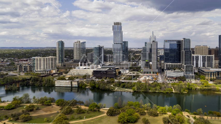 A view of city skyscrapers across Lady Bird Lake, Downtown Austin, Texas Aerial Stock Photos DXP002_102_0011