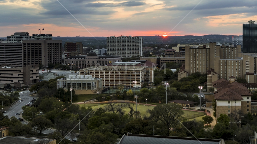 The setting sun in the distance while flying near the university, Austin, Texas Aerial Stock Photo DXP002_105_0013 | Axiom Images