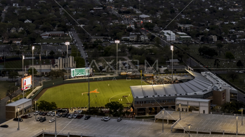 A baseball game at a stadium at the University of Texas at twilight, Austin, Texas Aerial Stock Photo DXP002_105_0018 | Axiom Images