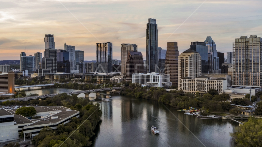 A view of Lady Bird Lake and the skyline at sunset in Downtown Austin, Texas Aerial Stock Photos DXP002_110_0005