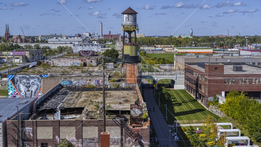 A water tower atop an abandoned brick building in Detroit, Michigan Aerial Stock Photo DXP002_194_0013 | Axiom Images