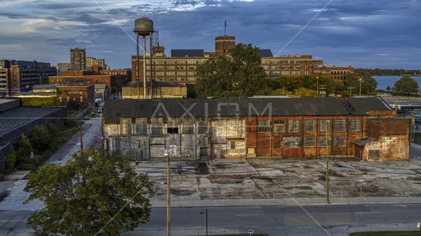Abandoned factory building and water tower at sunset, Detroit, Michigan Aerial Stock Photo DXP002_197_0003 | Axiom Images