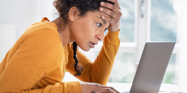 stressed woman using a laptop