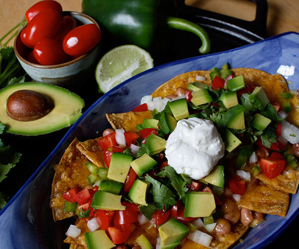 healthy nachos with tomato, avocado, and greek yogurt | beach