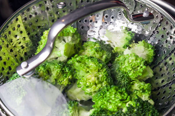Freshly cooked green broccoli in a saucepan.