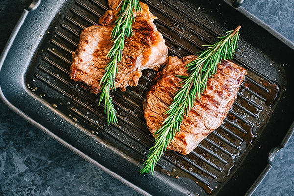 Bison slices in a frying pan