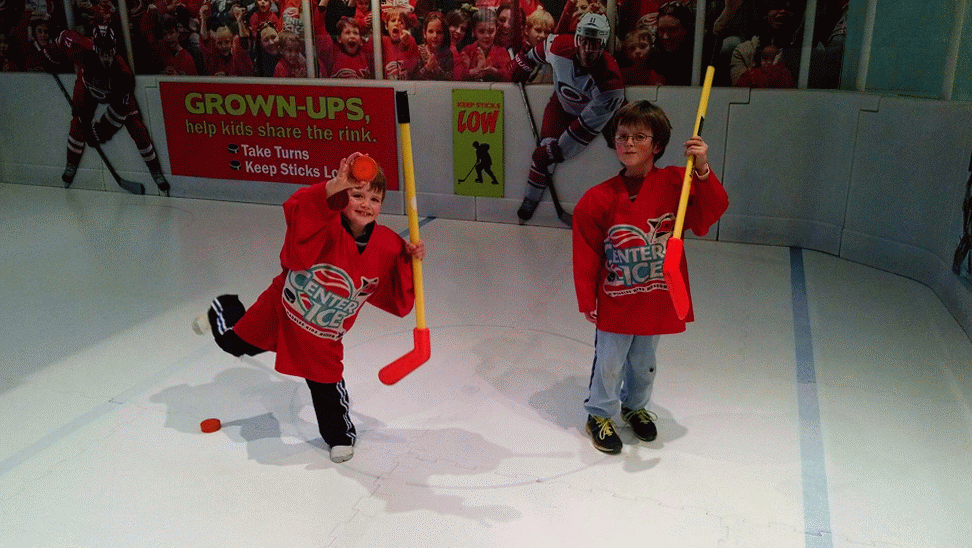 The boys getting their hockey fix at Marbles.