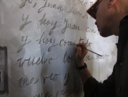 Andy Shallal painting mural at Busboys and Poets